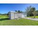 Exterior view of the home's outbuildings, featuring a shed and garage, on a sunny day at 80 Liles St, Terra Ceia, FL 34250