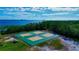 Aerial view of the pickleball court surrounded by trees, offering a serene and active lifestyle at 80 Liles St, Terra Ceia, FL 34250