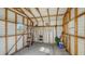 View of the shed with a ladder, tools, and equipment neatly arranged, offering practical storage solutions at 80 Liles St, Terra Ceia, FL 34250