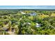 Aerial view of property surrounded by trees, lake, and golf course at 801 Oak Vista Dr, Sarasota, FL 34232