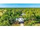 Aerial view showcases the home nestled among lush greenery at 801 Oak Vista Dr, Sarasota, FL 34232
