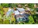 Stunning aerial view showcasing the home's private pool, screened lanai, and metal roof at 801 Oak Vista Dr, Sarasota, FL 34232