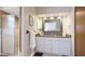 Bright bathroom with white vanity, granite countertop, and glass-enclosed shower at 801 Oak Vista Dr, Sarasota, FL 34232