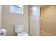 Bathroom featuring a toilet and shower with glass doors and neutral tile at 801 Oak Vista Dr, Sarasota, FL 34232