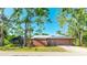 Charming single-story home with a two-car garage, screened-in lanai, and well-maintained lawn, surrounded by mature trees at 801 Oak Vista Dr, Sarasota, FL 34232