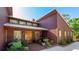Charming entrance with a wooden door and well-manicured landscaping surrounding the front of the house at 801 Oak Vista Dr, Sarasota, FL 34232