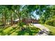 Stunning single Gathering home with a metal roof, mature trees, and a welcoming circular driveway at 801 Oak Vista Dr, Sarasota, FL 34232