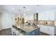 Well-lit open kitchen boasts white cabinetry, a center island with seating, and modern appliances at 801 Oak Vista Dr, Sarasota, FL 34232
