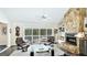 Light-filled living room boasts a stone fireplace, built-in shelving, and seamless access to the outdoor pool area at 801 Oak Vista Dr, Sarasota, FL 34232