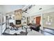 Spacious living room with a stone fireplace, built-in bookshelves, and large windows at 801 Oak Vista Dr, Sarasota, FL 34232