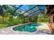Enclosed pool with lounge and outdoor kitchen at 801 Oak Vista Dr, Sarasota, FL 34232