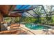 Screened-in pool area with lounge chairs and patio at 801 Oak Vista Dr, Sarasota, FL 34232