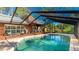 Large screened pool, wood deck, and seating area at 801 Oak Vista Dr, Sarasota, FL 34232