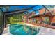 Sparkling pool with a screened enclosure and adjacent patio for relaxation and entertainment at 801 Oak Vista Dr, Sarasota, FL 34232
