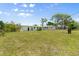 Expansive backyard showing rear exterior of the house on a sunny day at 815 31St W Ave, Palmetto, FL 34221