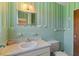 Bathroom featuring green tile, vintage vanity, and decorative mirror at 815 31St W Ave, Palmetto, FL 34221