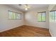 Bedroom featuring wood floors, a ceiling fan, and dual windows at 815 31St W Ave, Palmetto, FL 34221