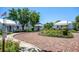 Charming community featuring quaint cottages with white trim, surrounded by lush landscaping and brick pathways at 815 31St W Ave, Palmetto, FL 34221