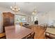 Open-concept dining room featuring a chandelier and hardwood floors at 815 31St W Ave, Palmetto, FL 34221