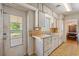 Kitchen featuring a double sink, cabinetry and door with window at 815 31St W Ave, Palmetto, FL 34221