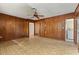 Living room featuring wood paneled walls, tiled floors, and a ceiling fan at 815 31St W Ave, Palmetto, FL 34221