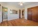 Bedroom with wood floors, ceiling fan, and access to bathroom and closet space at 815 31St W Ave, Palmetto, FL 34221