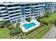 Stunning aerial shot of a building showcasing its luxurious pool, green surroundings, and access to parking at 1000 Riverside Dr # B202, Palmetto, FL 34221
