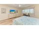 Cozy bedroom with a ceiling fan, TV, and a desk near the window at 1000 Riverside Dr # B202, Palmetto, FL 34221