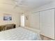 Well-lit bedroom with a spacious closet for ample storage, complemented by a ceiling fan and a wooden floor at 1000 Riverside Dr # B202, Palmetto, FL 34221