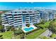 Modern condominiums featuring a sparkling pool, well maintained landscaping, and balconies with views at 1000 Riverside Dr # B202, Palmetto, FL 34221