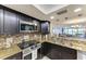 Updated kitchen with a stainless steel stove, microwave, and open to the living area at 1000 Riverside Dr # B202, Palmetto, FL 34221