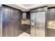 Modern kitchen with dark cabinetry, stainless steel refrigerator, and granite countertops at 1000 Riverside Dr # B202, Palmetto, FL 34221