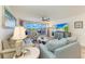 Cozy living room with sliding doors to the balcony, a ceiling fan, and comfortable seating at 1000 Riverside Dr # B202, Palmetto, FL 34221