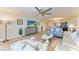 Open-concept living area with a view into the kitchen, comfortable furniture and bright decor at 1000 Riverside Dr # B202, Palmetto, FL 34221