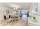Open-concept living and dining area with light wood floors and sliding glass doors to a balcony at 1000 Riverside Dr # B202, Palmetto, FL 34221