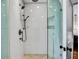 Bright bathroom features a glass shower with mosaic tile floor, sleek fixtures, and white subway tile at 103 Park Ave, Anna Maria, FL 34216