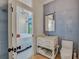 Stylish bathroom featuring blue tile walls, a white vanity, and an open doorway that peeks into the main bedroom at 103 Park Ave, Anna Maria, FL 34216