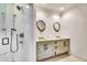 Bathroom featuring double sinks with custom cabinetry and a full shower at 103 Park Ave, Anna Maria, FL 34216