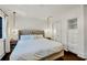 Bright bedroom features hardwood floors, decorative lighting, a luxurious bed, built-in shelving, and closet at 103 Park Ave, Anna Maria, FL 34216
