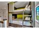 Comfortable built-in bunk bed featuring curtains, storage and accent lighting at 103 Park Ave, Anna Maria, FL 34216