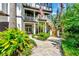 Beautiful home featuring a balcony, outdoor staircase, and meticulously landscaped yard at 103 Park Ave, Anna Maria, FL 34216