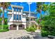 Stunning home with two-car garage, second-story balcony, and mature landscaping at 103 Park Ave, Anna Maria, FL 34216