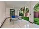 Inviting game room with a ping pong table, white tile floor, and direct access to backyard at 103 Park Ave, Anna Maria, FL 34216