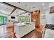 Open-concept kitchen boasts marble island, hardwood floors, stainless appliances, and easy access to the living area at 103 Park Ave, Anna Maria, FL 34216