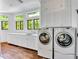 Well-equipped laundry room with custom cabinets, sink, countertop space, and washer/dryer units at 103 Park Ave, Anna Maria, FL 34216