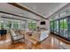 An airy living room featuring hardwood floors, wooden ceiling beams and garden views at 103 Park Ave, Anna Maria, FL 34216