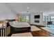 Serene main bedroom with king bed, modern fireplace, TV, and scenic window views offers a relaxing retreat at 103 Park Ave, Anna Maria, FL 34216