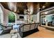 Outdoor living space features a ceiling fan, wicker furniture, and a covered patio at 103 Park Ave, Anna Maria, FL 34216