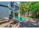 Spacious backyard pool with wood deck, lounge chairs and outdoor grill at 103 Park Ave, Anna Maria, FL 34216