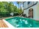 Inviting backyard pool with a diving board and an outdoor dining area at 103 Park Ave, Anna Maria, FL 34216